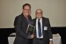 Dr. Nagib Callaos, General Chair, giving Dr. Peter Smit a plaque "In Appreciation for Delivering a Great Keynote Address at a Plenary Session."